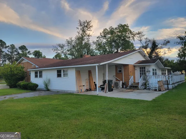 a front view of house with yard and outdoor seating