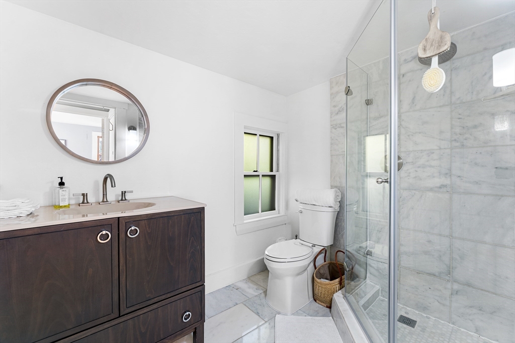 29 Cottage Street Wellesley, MA 02482 - Photo 14 of 42 a bathroom with a toilet a sink and mirror