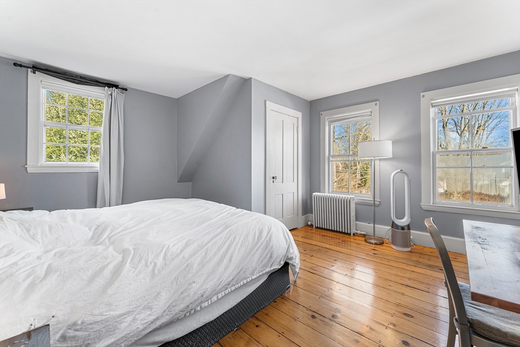 29 Cottage Street Wellesley, MA 02482 - Photo 15 of 42 a bedroom with a bed a dresser and wooden floor