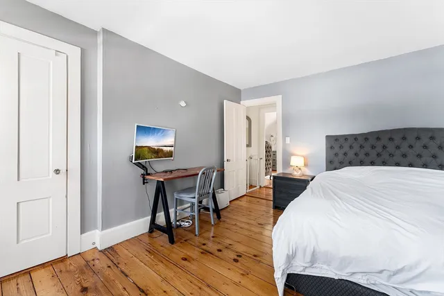 a bedroom with a bed and a table