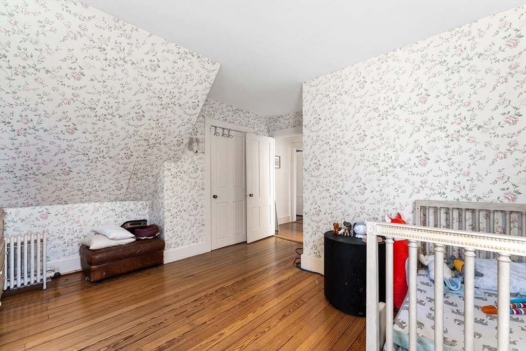 29 Cottage Street Wellesley, MA 02482 - Photo 20 of 42 a hallway with a couch and a stove with wooden floor