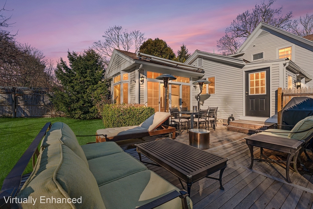29 Cottage Street Wellesley, MA 02482 - Photo 26 of 42 a view of a patio with table and chairs and potted plants with wooden floor and fence