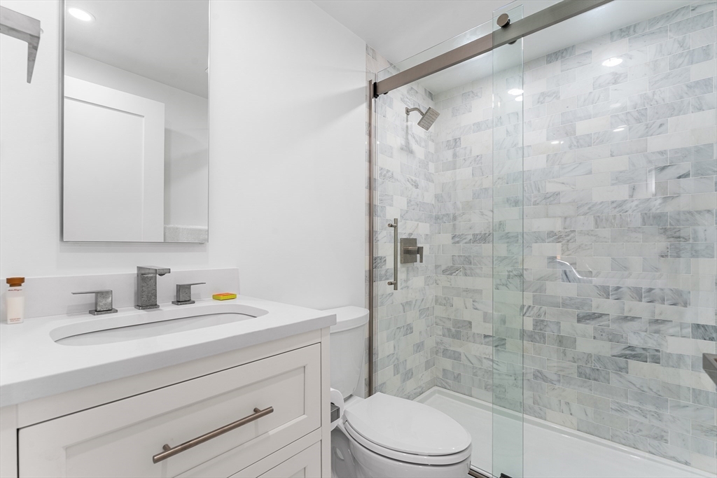 29 Cottage Street Wellesley, MA 02482 - Photo 36 of 42 a bathroom with a sink a toilet and shower