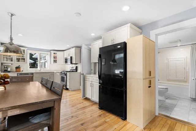 a kitchen with a refrigerator a sink and cabinets