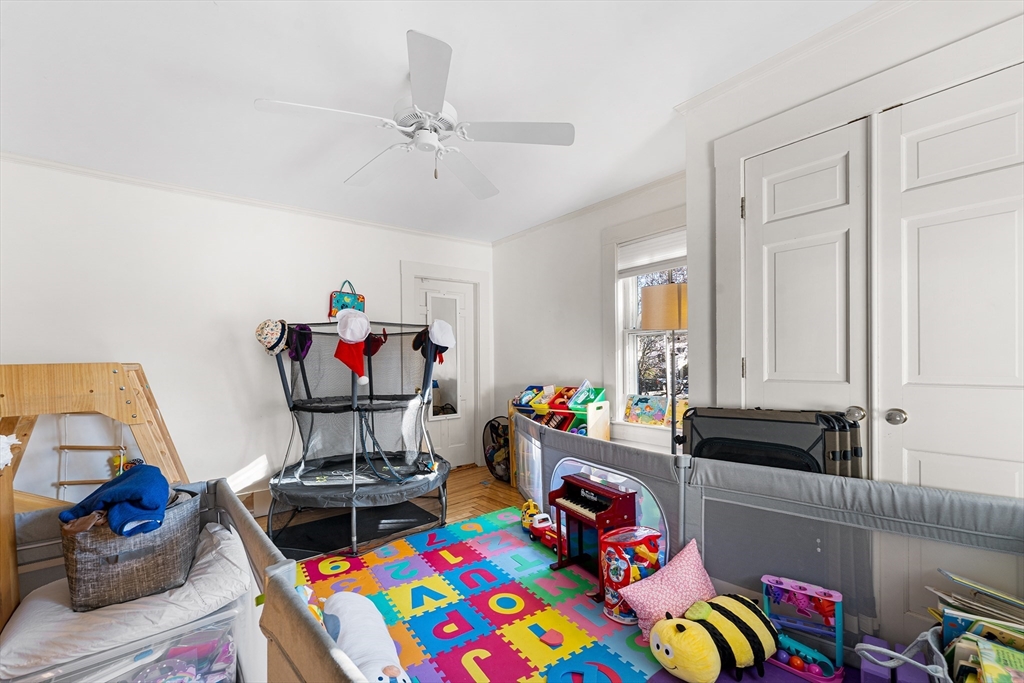 29 Cottage Street Wellesley, MA 02482 - Photo 9 of 42 a living room with furniture and a baby crib