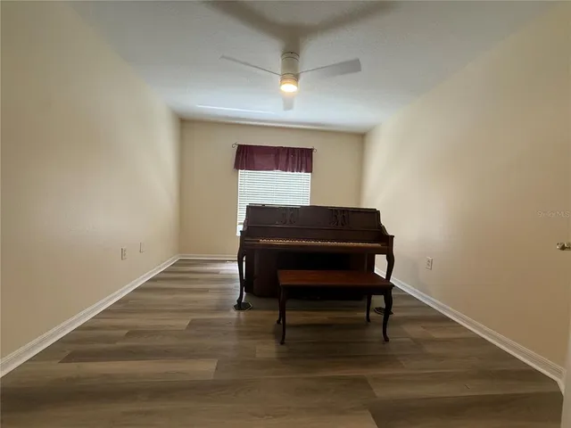 a room with a piano and wooden floor