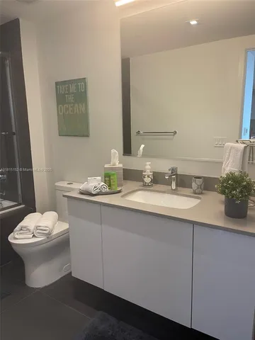 a bathroom with a shower and a glass door