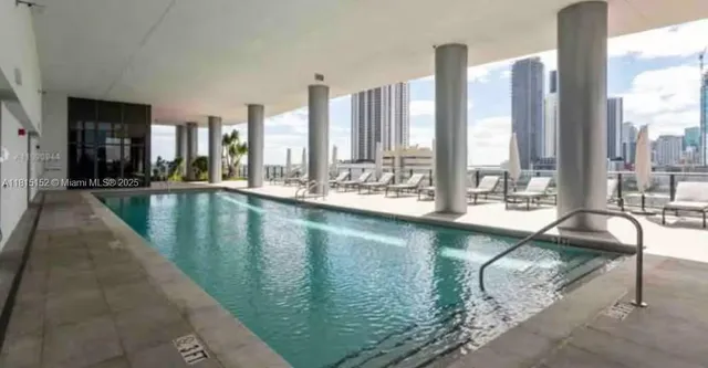 a view of swimming pool with a yard