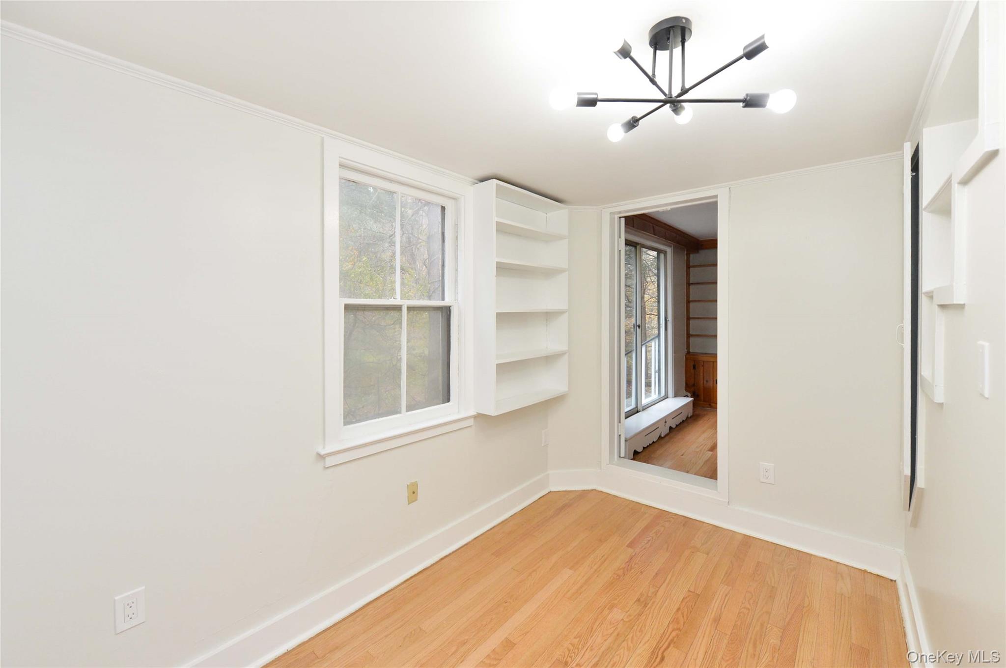 19 Johnsontown Road Sloatsburg, NY 10974 - Photo 13 of 41 Empty room with a chandelier and light wood-style floors