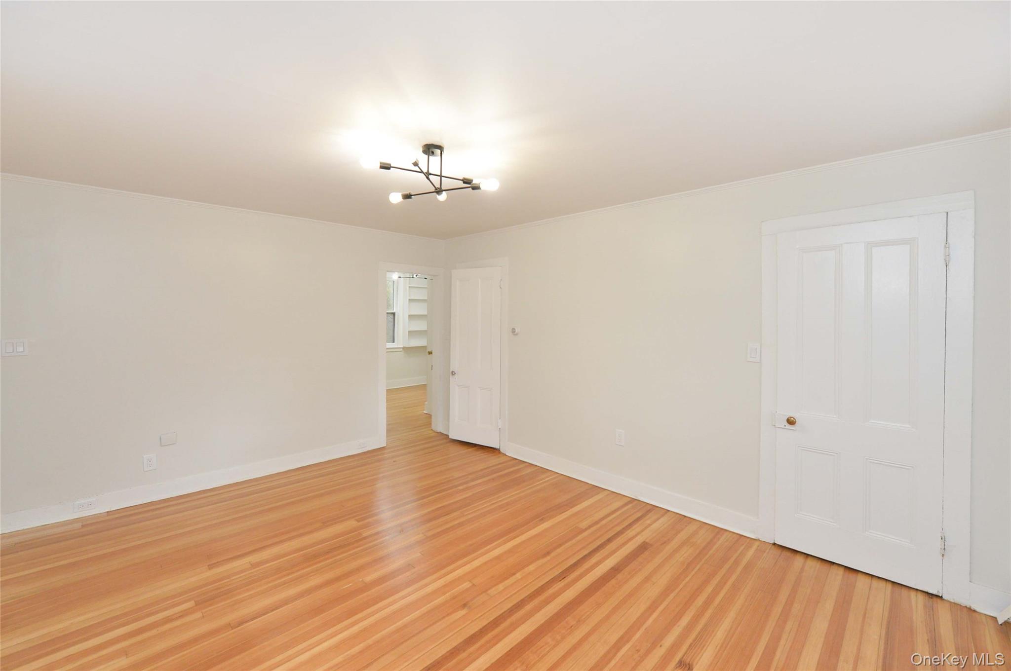 19 Johnsontown Road Sloatsburg, NY 10974 - Photo 16 of 41 Empty room featuring a chandelier and light wood-style flooring
