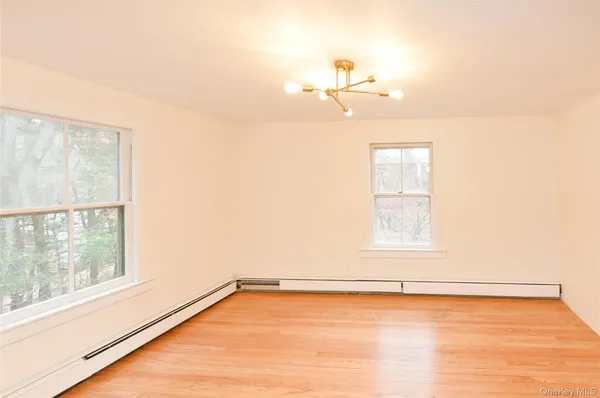a view of a room with an empty space and a window