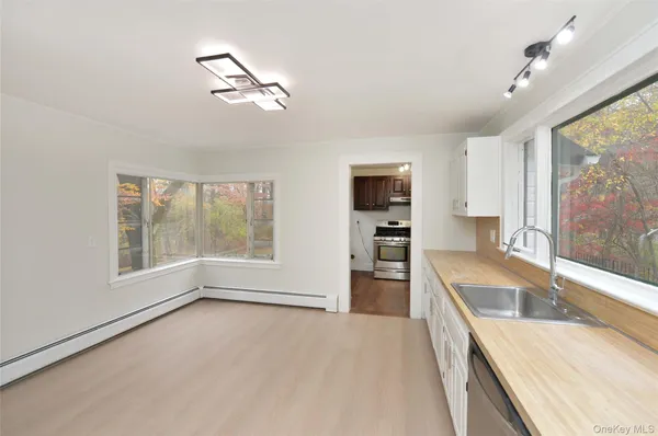 a large kitchen with granite countertop a large window and a sink