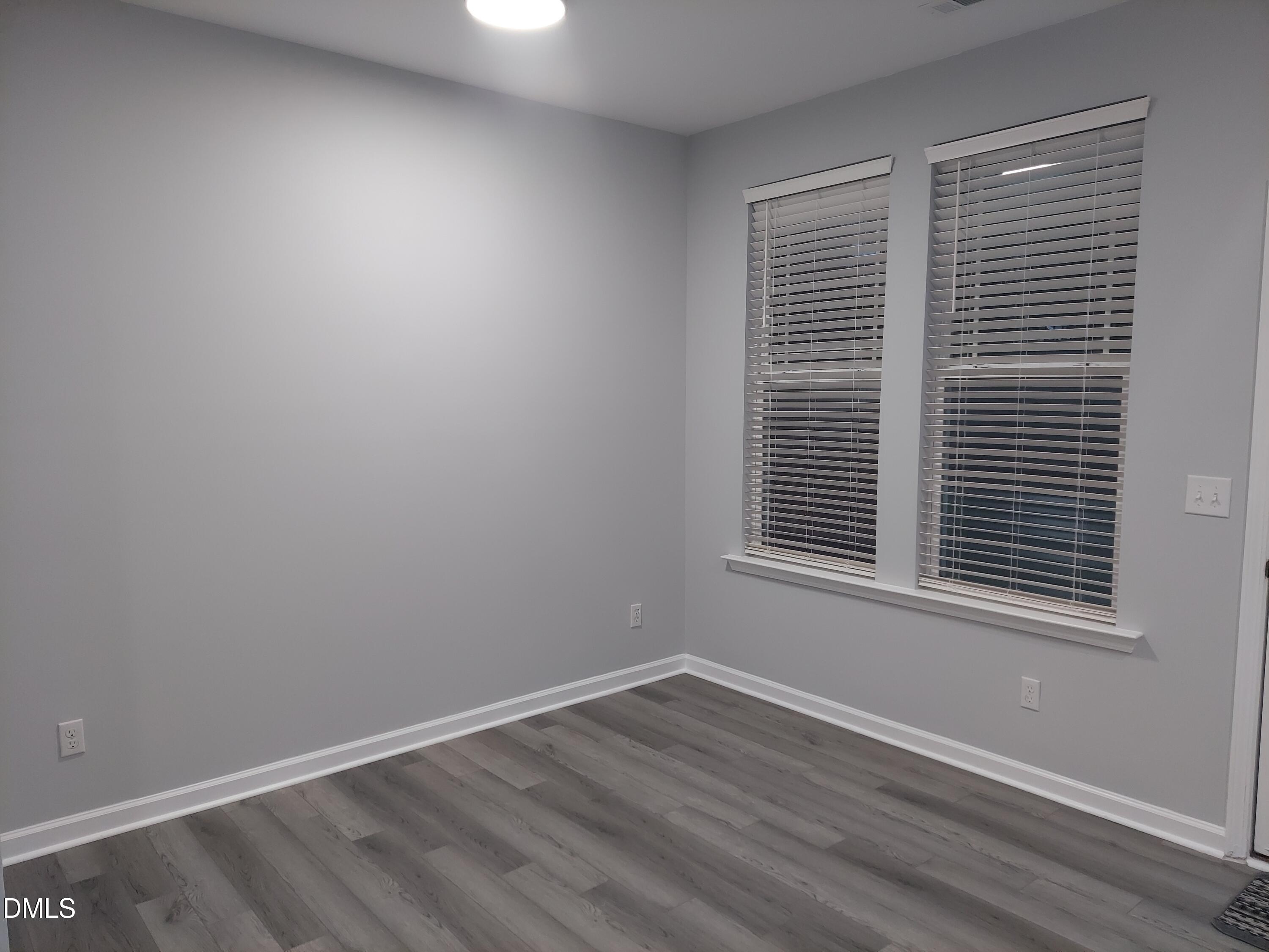 408 Timpson Avenue Durham, NC 27703 - Photo 5 of 14 a view of an empty room with wooden floor and a window