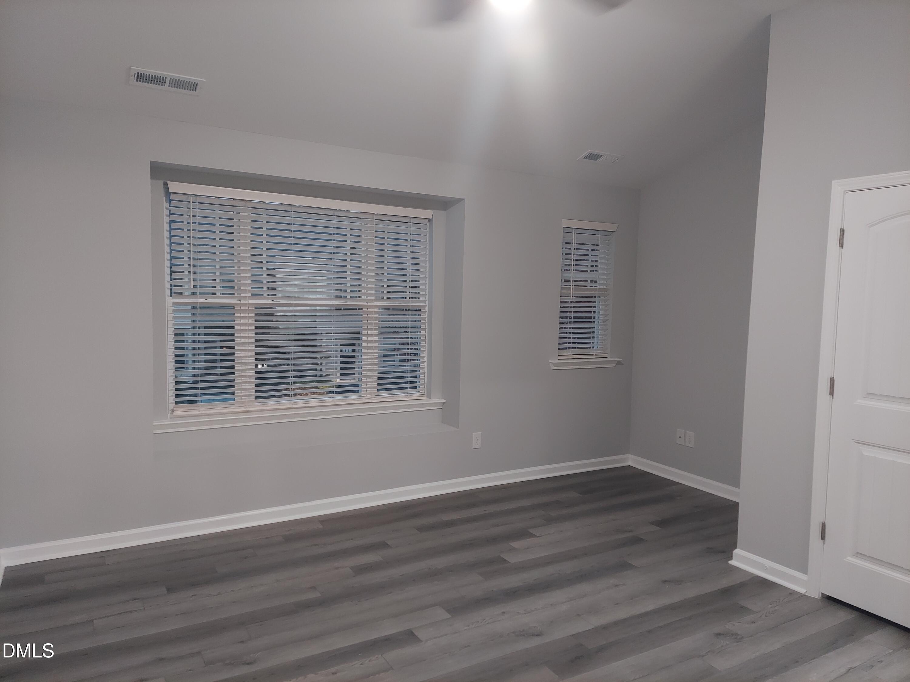 408 Timpson Avenue Durham, NC 27703 - Photo 7 of 14 a view of an empty room with wooden floor and a window