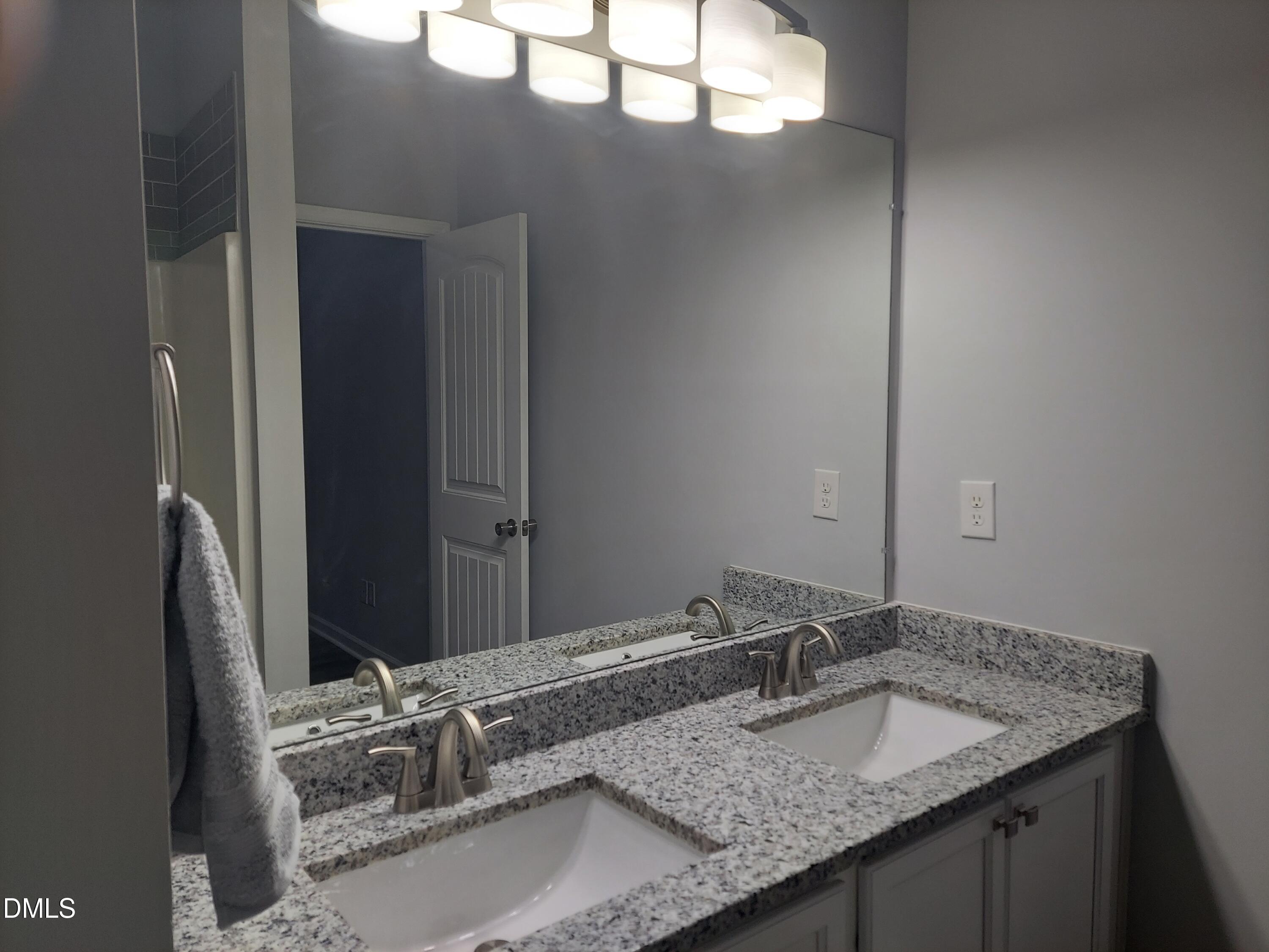 408 Timpson Avenue Durham, NC 27703 - Photo 8 of 14 a bathroom with a granite countertop sink and a mirror
