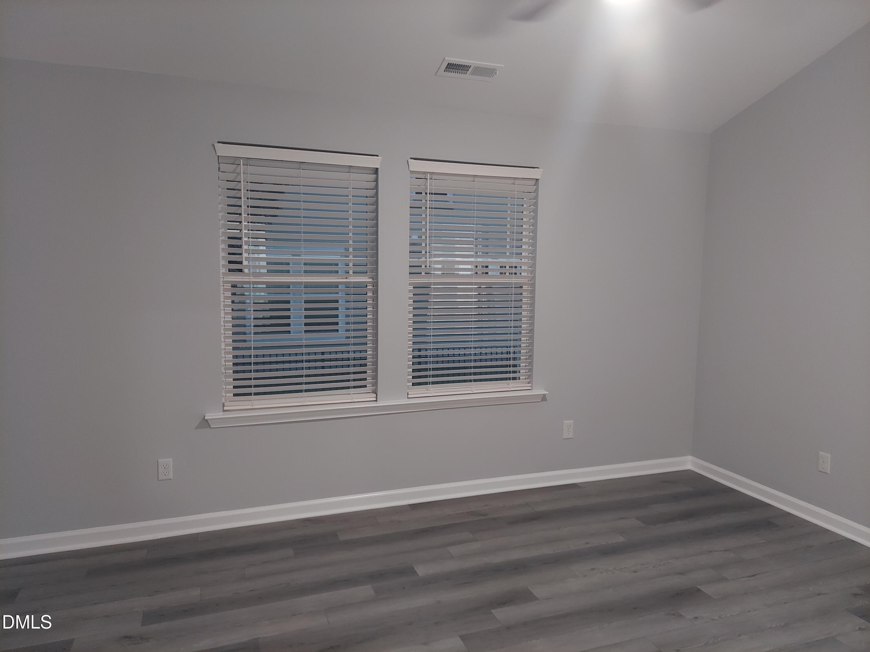 408 Timpson Avenue Durham, NC 27703 - Photo 9 of 14 a view of an empty room with wooden floor and a window