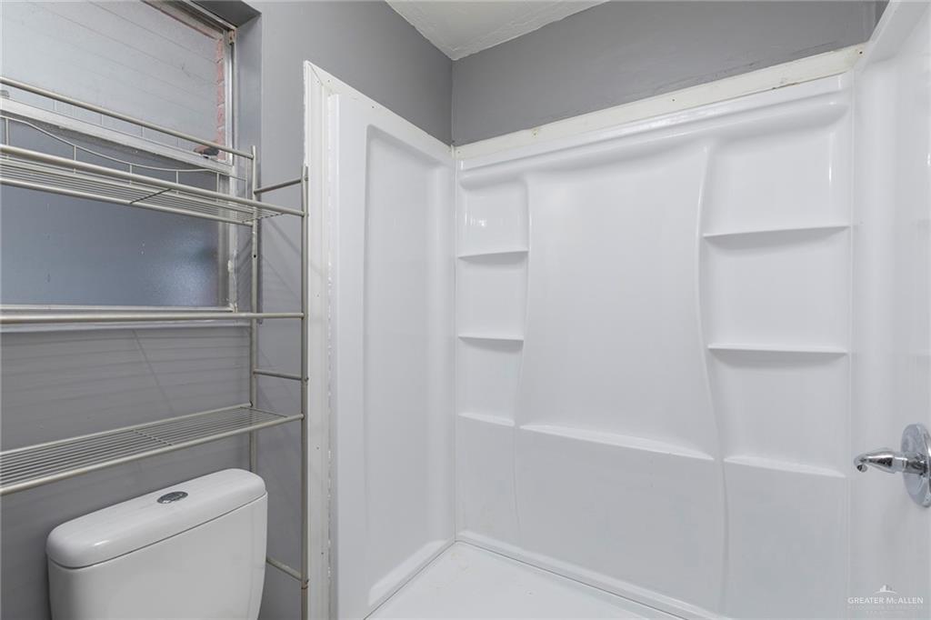 3417 North Kenyon Road Edinburg, TX 78542 - Photo 9 of 12 a bathroom with a shower and toilet