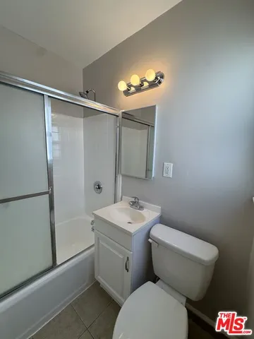 a bathroom with a toilet sink and shower