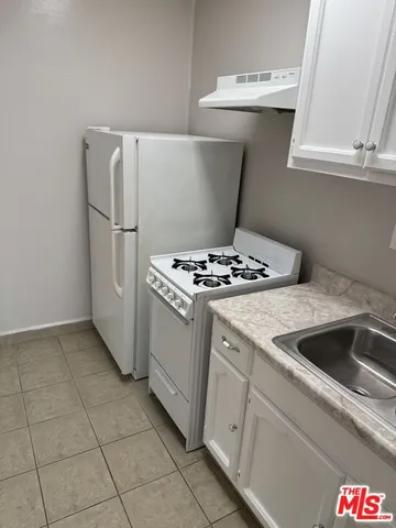 a kitchen with cabinets and appliances