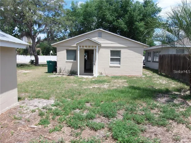 a view of a house with yard and sitting area