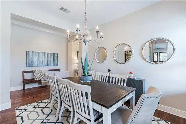a view of a dining room with furniture and a chandelier