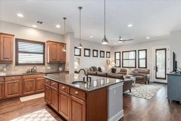a kitchen with granite countertop a sink and stove