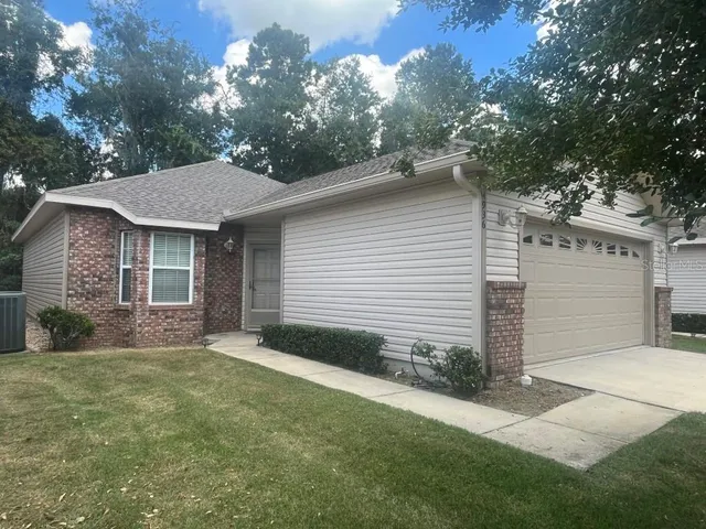 a front view of a house with a garden and yard