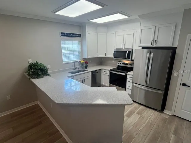 a kitchen with stainless steel appliances a refrigerator and a stove