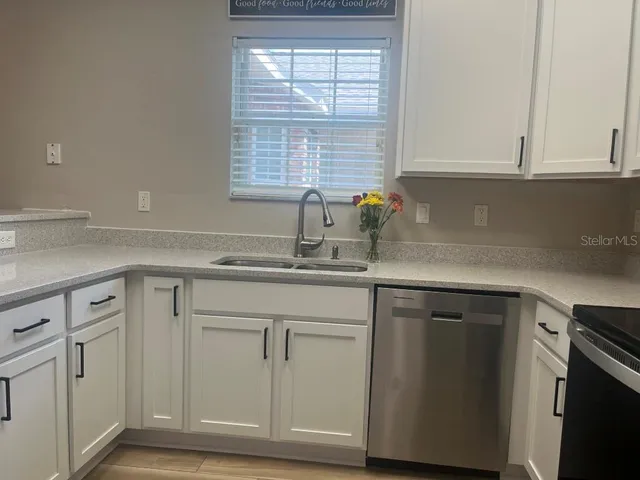 a kitchen with stainless steel appliances a refrigerator stove and microwave