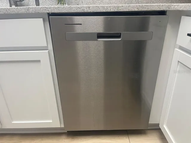 a stove top oven sitting inside of a kitchen