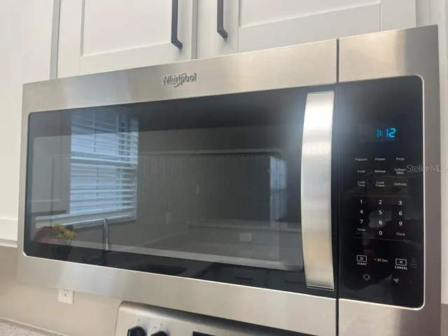 a kitchen with a refrigerator stove and microwave
