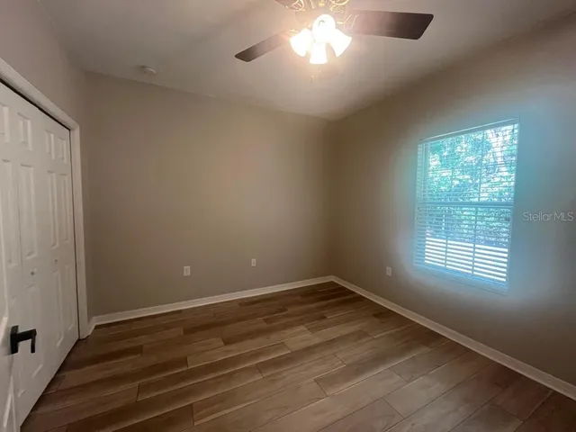 wooden floor in an empty room with a window