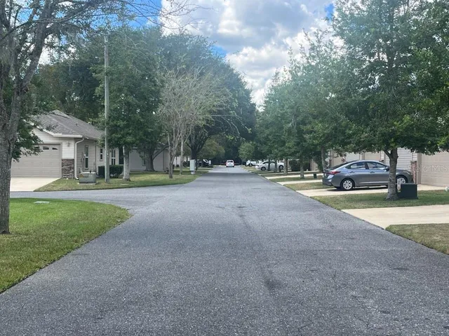 a view of a yard with yellow house