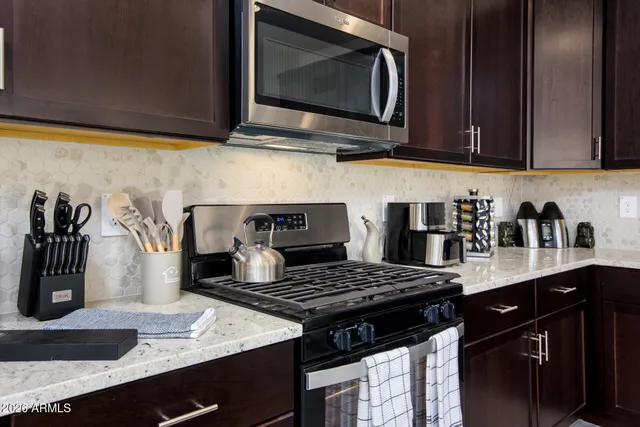 a kitchen with a sink stove and cabinets