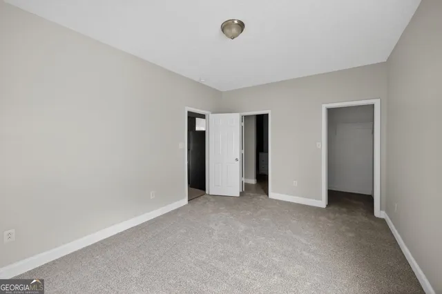 a view of an empty room and closet area