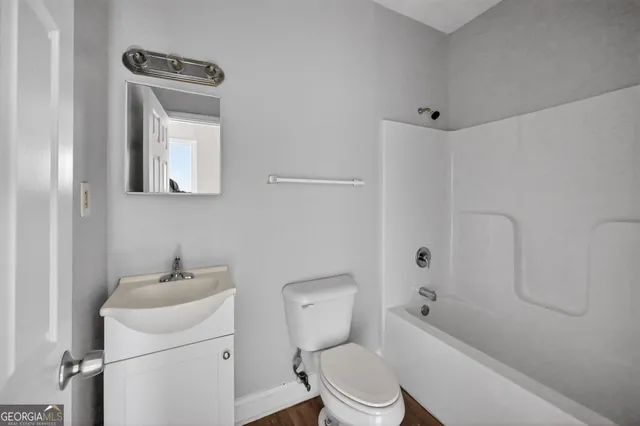 a white toilet sitting next to a bathroom sink