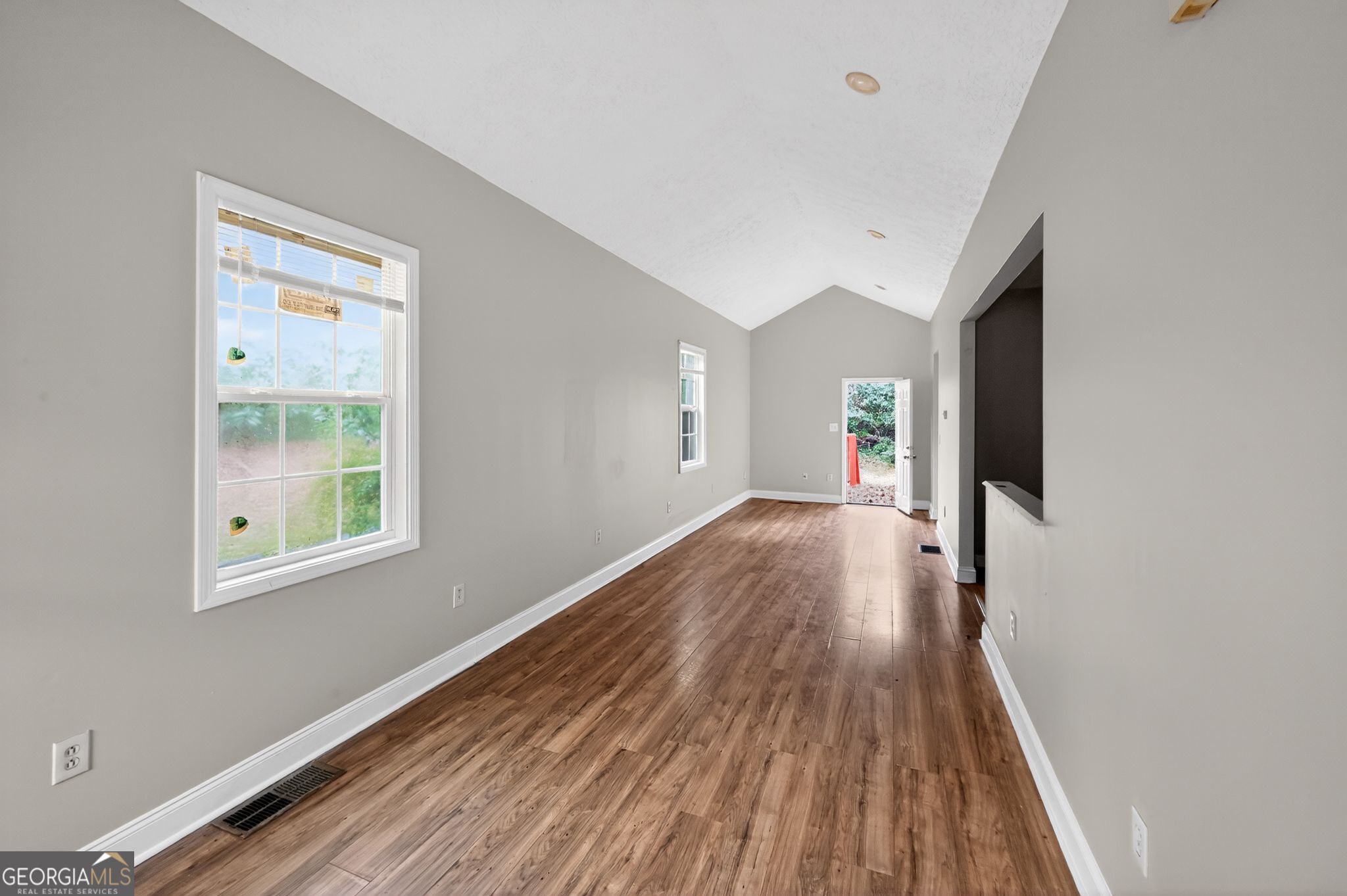 607 Lane Street Griffin, GA 30223 - Photo 4 of 31 a view of a big room with wooden floor and windows