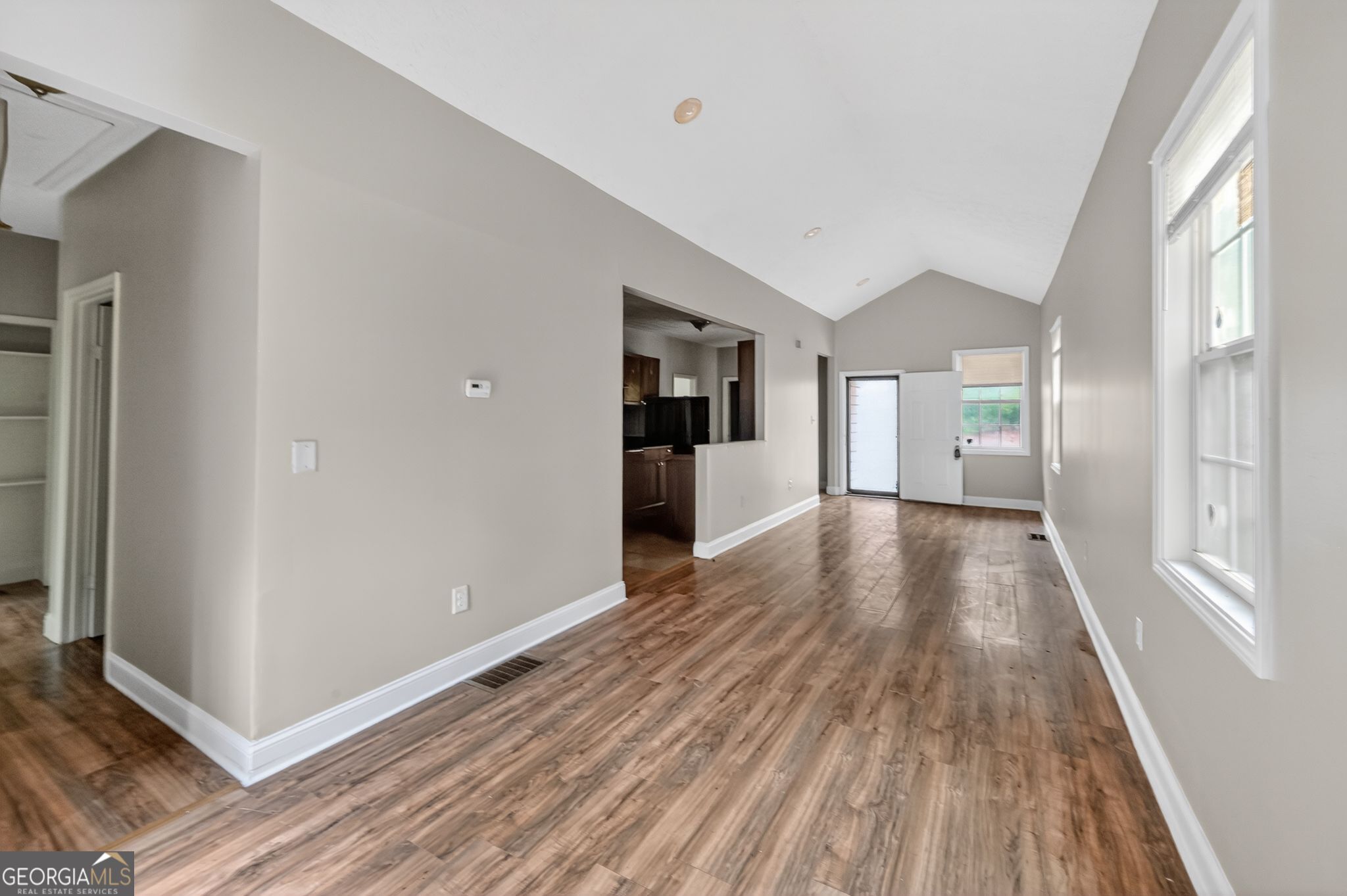 607 Lane Street Griffin, GA 30223 - Photo 6 of 31 a view of a big room with wooden floor and windows