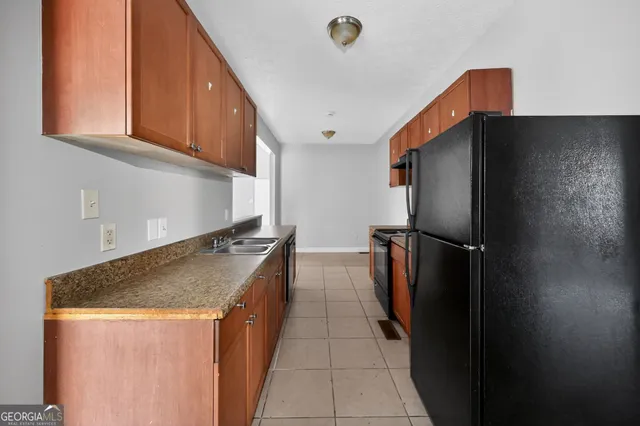 a kitchen with stainless steel appliances granite countertop a refrigerator and a sink