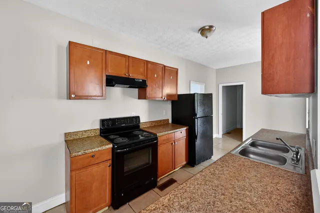 a kitchen with a sink stove and refrigerator