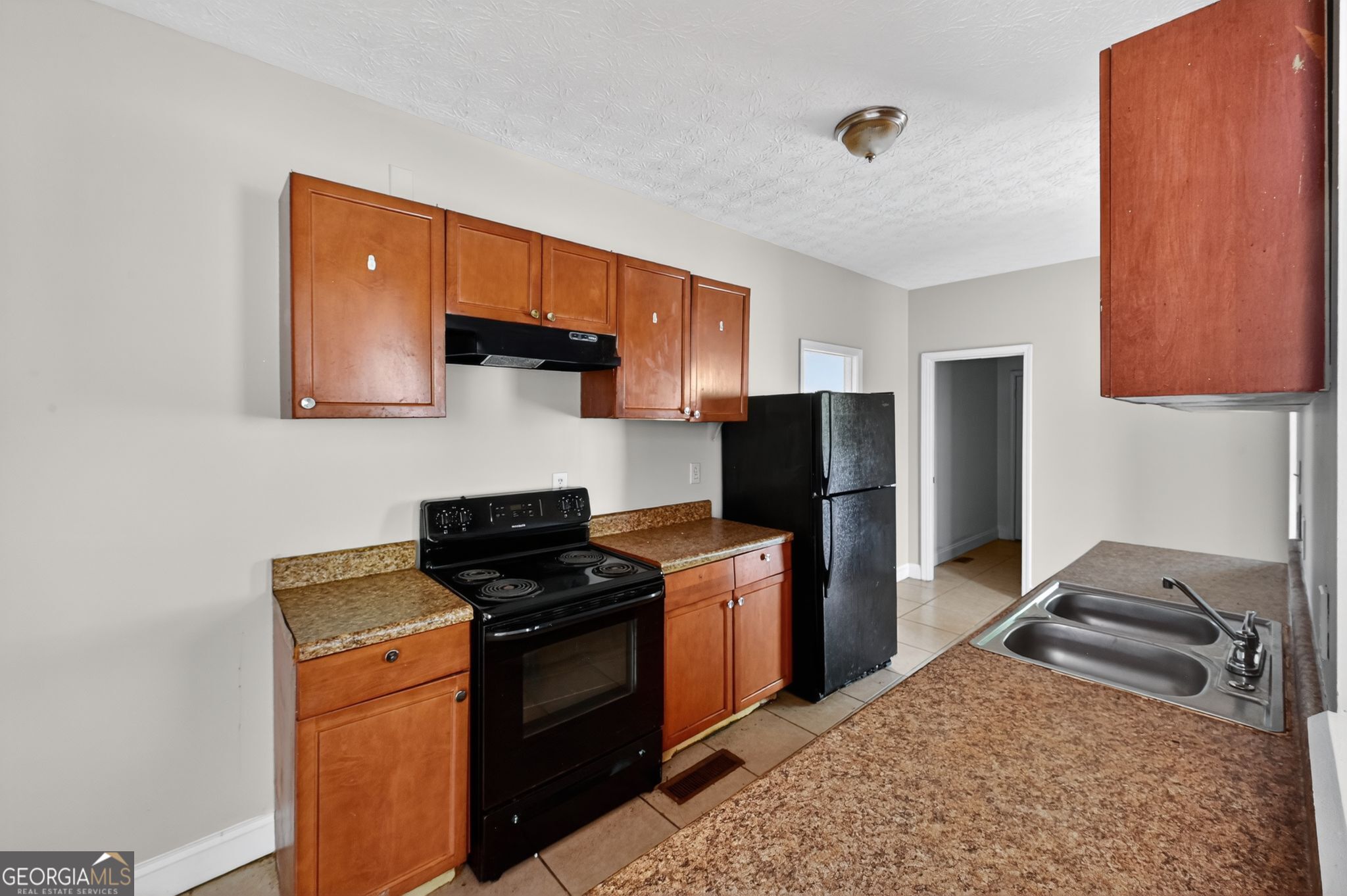 607 Lane Street Griffin, GA 30223 - Photo 9 of 31 a kitchen with a sink stove and refrigerator