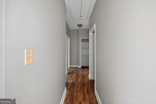 a view of a hallway with wooden floor