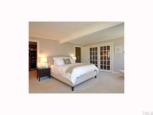 2117 St Marys Street Raleigh, NC 27608 - Photo 11 of 12 a bedroom with a large bed and a window