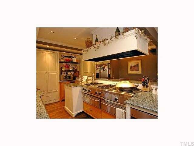 2117 St Marys Street Raleigh, NC 27608 - Photo 7 of 12 a kitchen with a stove and a refrigerator