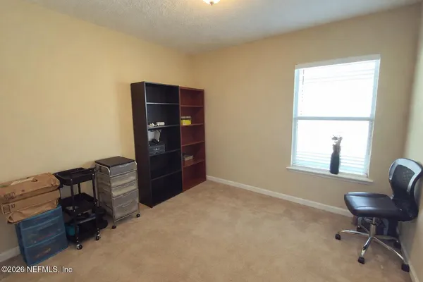 a livingroom with workspace and a window