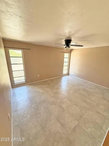 an empty room with windows and closet