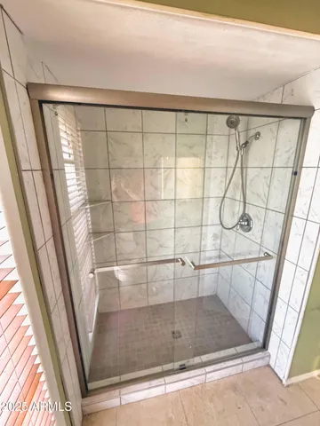 a bathroom with a glass shower door