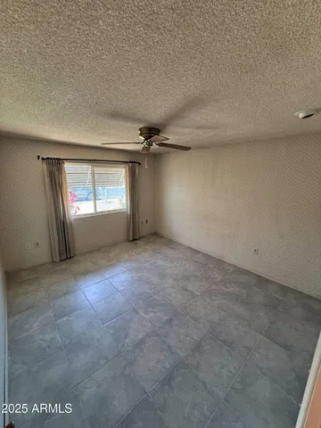 an empty room with windows and closet