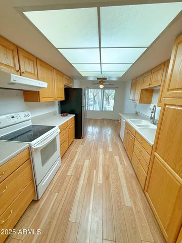 a kitchen with a stove a sink and a refrigerator