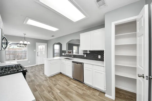 a kitchen with a sink cabinets and window